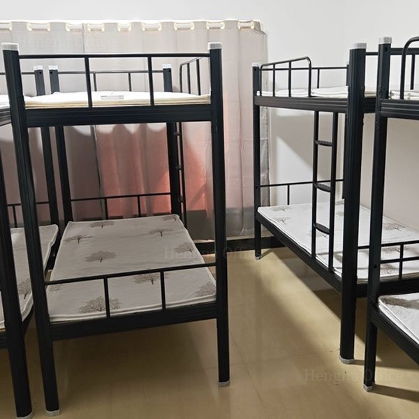 worker dormitory room fitted with rows of steel bed frames